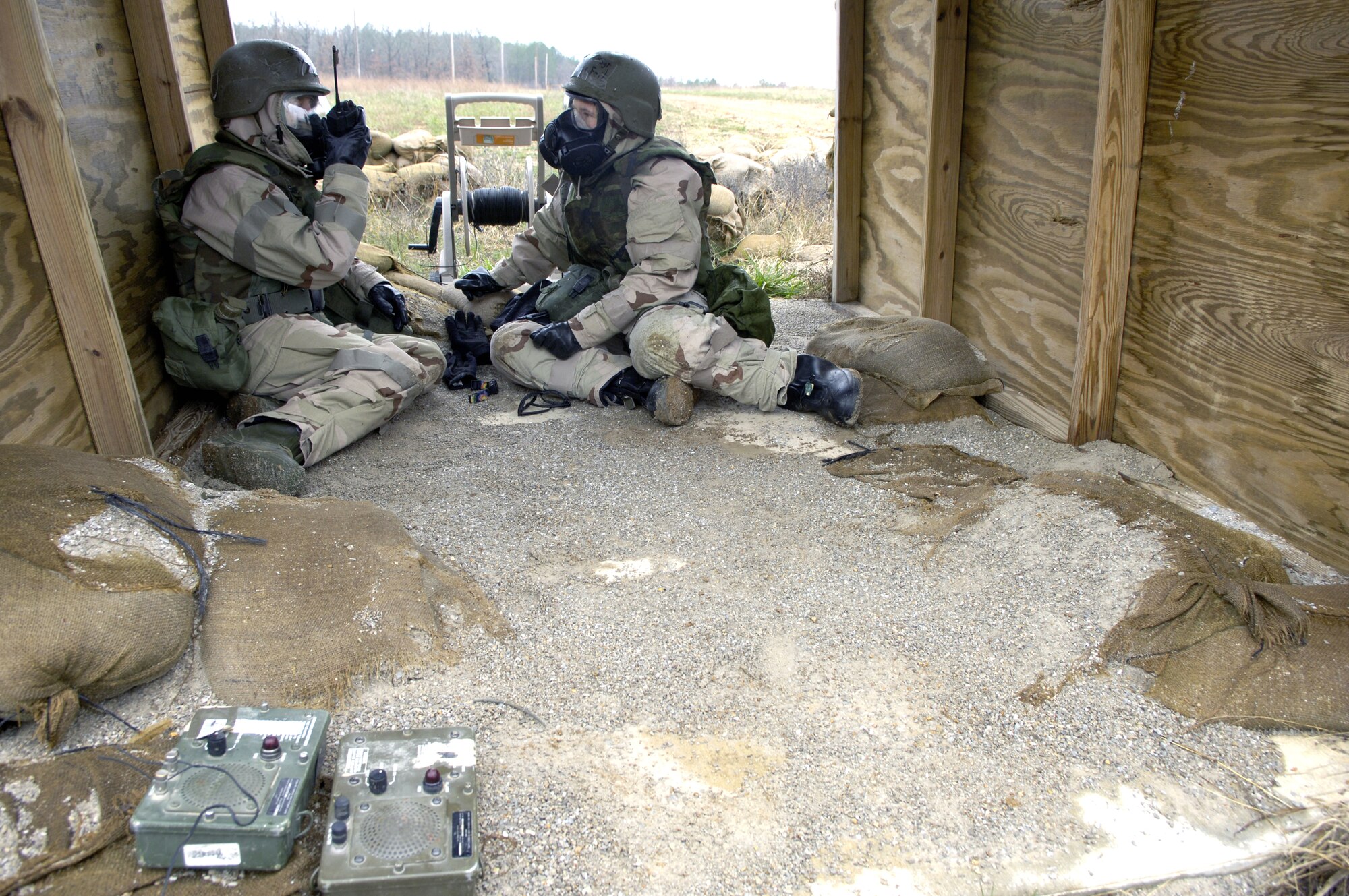 Staff Sgts. Jenna Klinkenberg (left) and Jessica Feil take cover in a bunker during a simulated attack Nov. 16. The attack was part of a readiness training exercise at Fort Leonard Wood, Mo. The exercise is designed to give readiness Airmen training scenarios developed from lessons learned during operations Iraqi Freedom and Enduring Freedom. The two-day exercise is the part of a two-week training class here. Sergeant Klinkenberg is with the 3rd Civil Engineer Squadron, Elmendorf Air Force Base, Alaska, and Sergeant Feil is with Detachment 1, 823rd Red Horse, Tyndall AFB, Fla.  (U.S. Air Force photo/Senior Airman Brian Ferguson) 