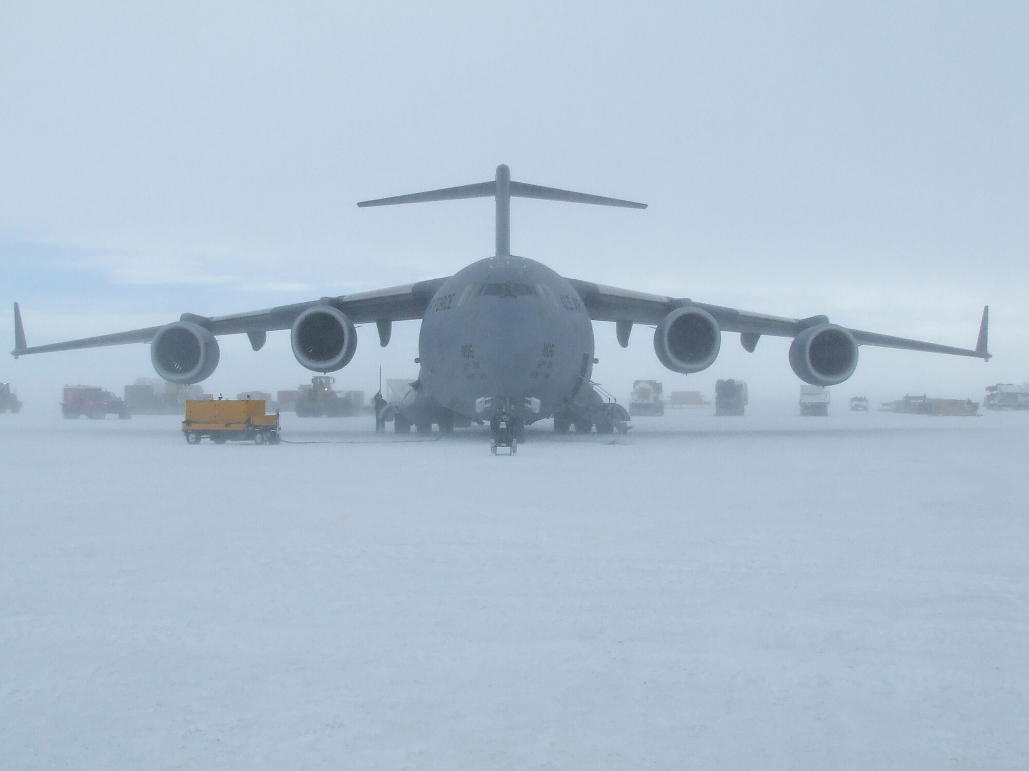 MCMURDO STATION, Antarctica - Vehicles transport National Science Foundation equipment and supplies off a McChord C-17 Globemaster III Nov. 14, 2006, which landed on the sea ice runway near here. U.S. Air Force Photo/ By 1st Lt Erika Yepsen
