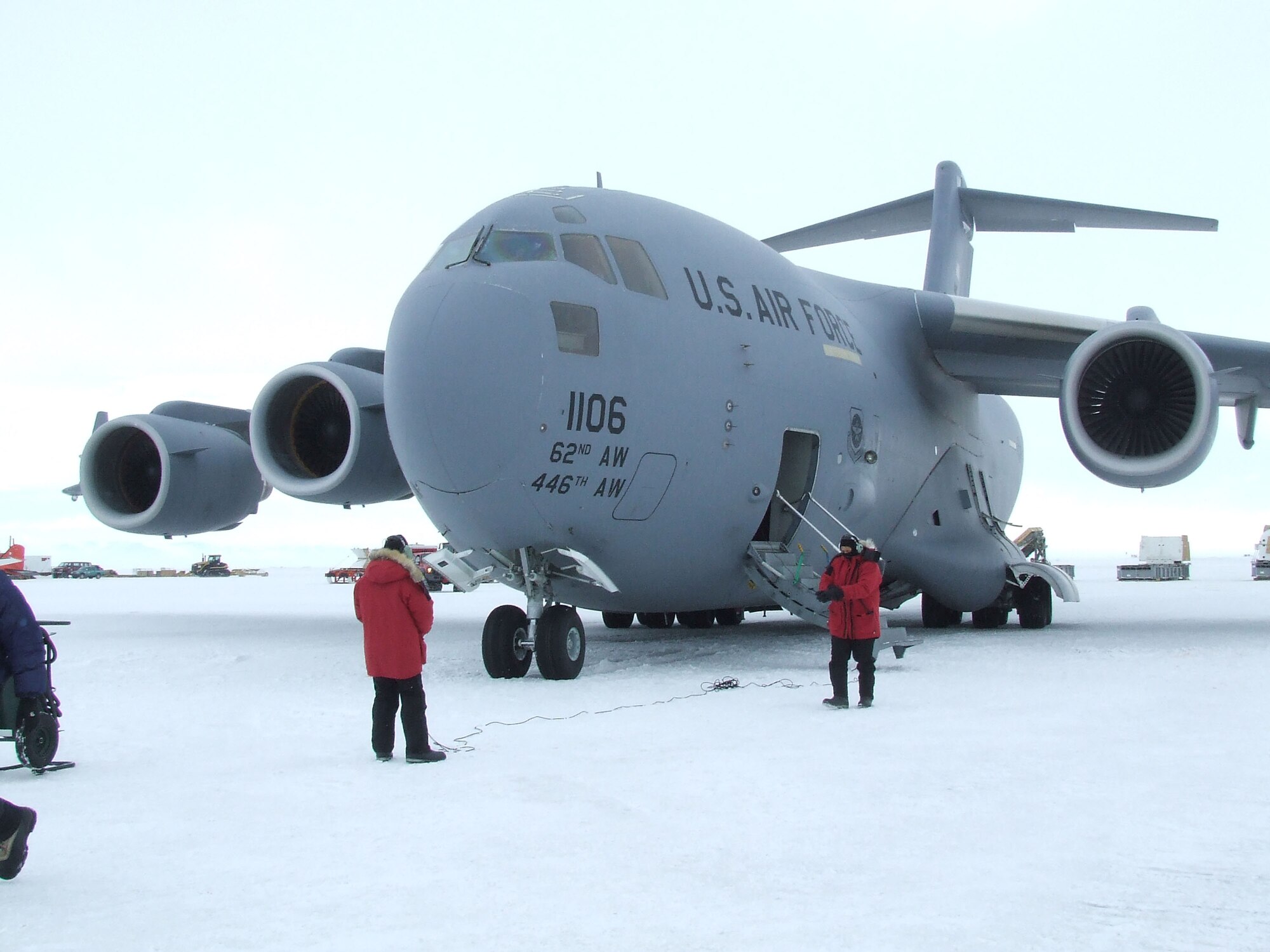 MCMURDO STATION, Antarctica - From left, Senior Airman Kory Williams, 8th Airlift Squadron, and Senior Master Sgt. David Stutts, 313th Airlift Squadron, assess the C-17 Globemaster III's condition after landing on the ice runway Nov. 14, 2006, here. The McChord jet shuttled supplies, equipment and personnel for Operation Deep Freeze. U.S. Air Force Photo/ By 1st Lt Erika Yepsen