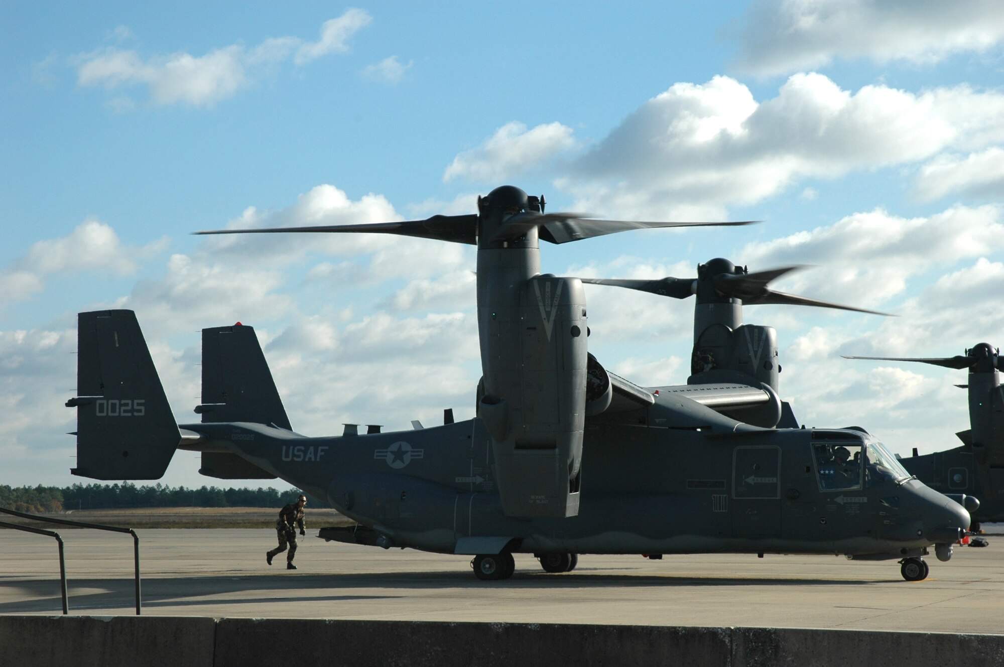 A crew chief prepares a CV-22 Osprey, getting ready to be flown by Lt. Gen. Michael Wooley, Air Force Special Operations Wing commander, for flight from Duke Field, Fla. to its welcoming ceremony at Hurlburt Field, Fla. Nov. 16. The 8th Special Operations Squadron there will utilize the aircraft to accomplish missions related to insertion, extraction, re-supply of forces and equipment, psychological operations, aerial reconnaisance, and helicopter air refueling. (U.S. Air Force Photo)