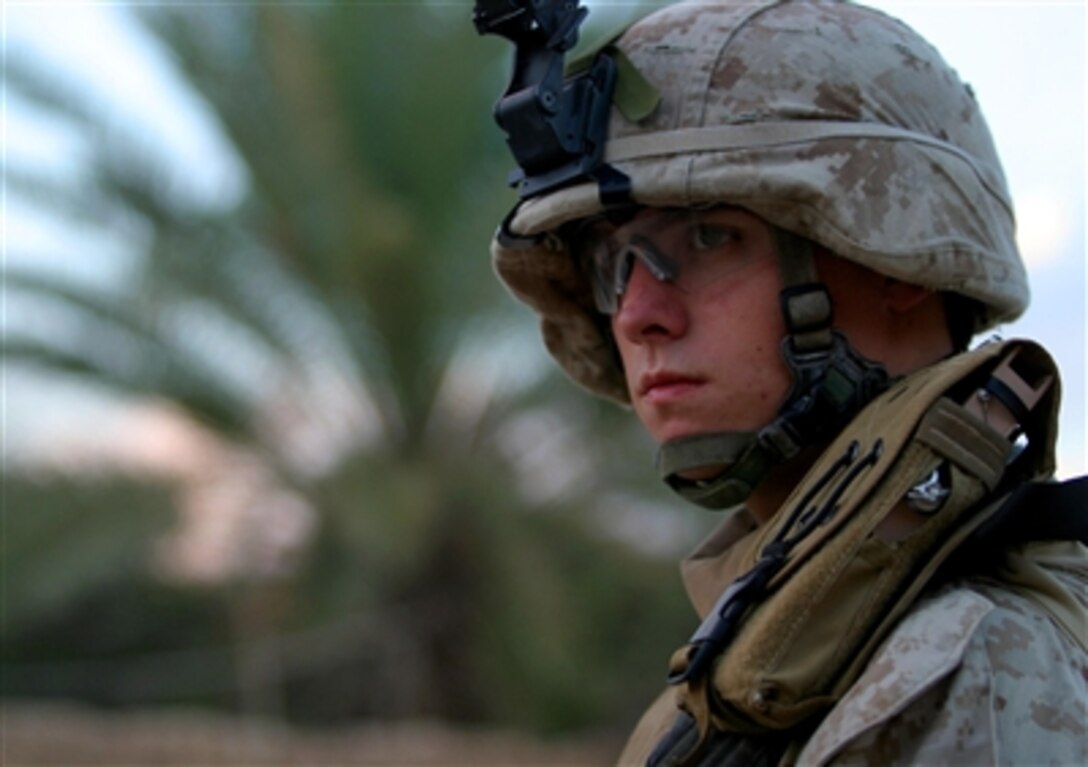 U.S. Marine Corps Lance Cpl. Bryan D. Reeves, from 3rd Battalion, 4th Marine Regiment, provides security during a patrol in Husaybah, Iraq, Nov. 3, 2006. 