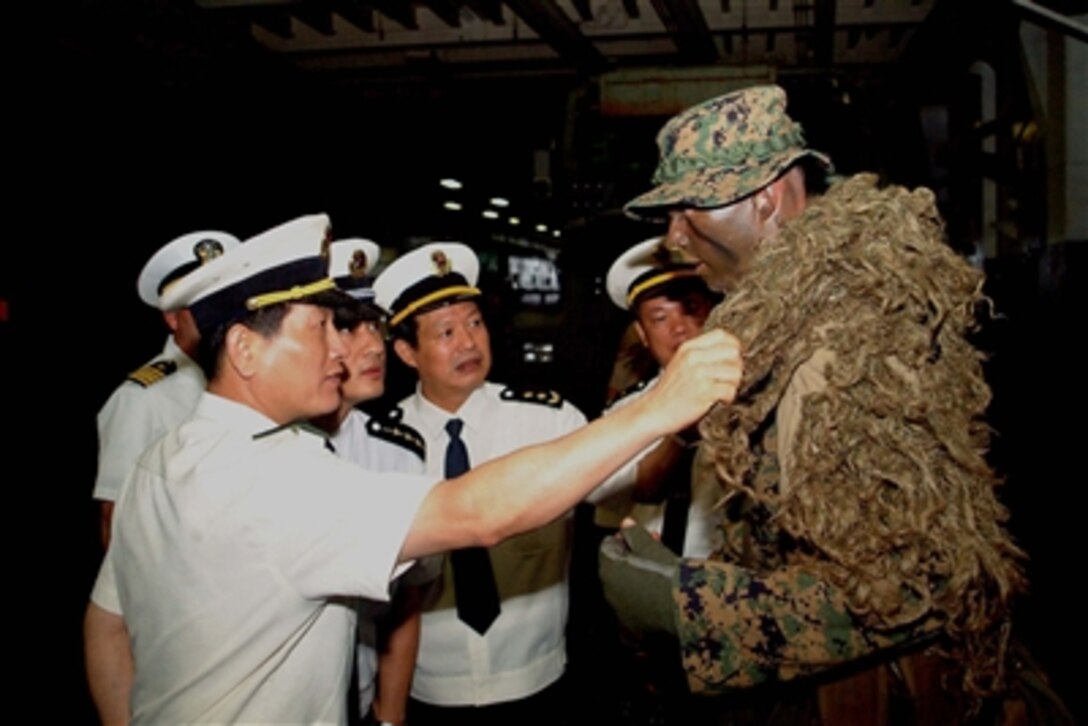 Vice Adm. Gu Wengen (left), People's Liberation Army Navy's commander for South Sea Fleet, and members of his staff examine the camouflage suit of a U.S. Marine aboard the USS Juneau (LPD 10) during a port visit to Zhanjing, Peoples Republic of China, on Nov. 16, 2006.   The Marine is attached to the 31st Marine Expeditionary Unit deployed on board the amphibious transport dock ship.  