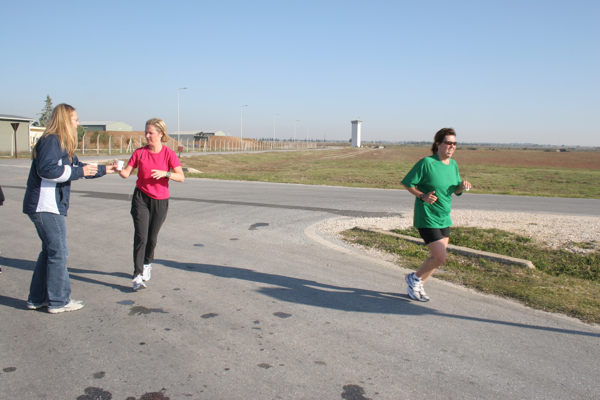 Nicole Kulas (green shirt) and Emily Ozgul (pink shirt) run past the water station by Arkadas Park during Incirlik's first half marathon Nov. 18. Both women have been training for the half marathon for more than nine weeks. This is Mrs. Kulas' fourth half marathon and Mrs. Ozgul's first. They finished just over two hours.
(U.S. Air Force photo by Senior Airman Patrice Clarke)