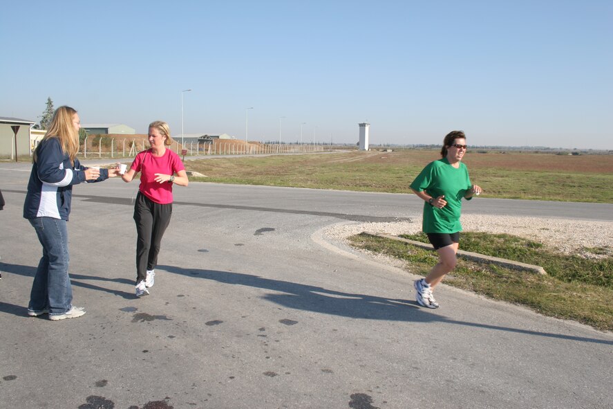 Nicole Kulas (green shirt) and Emily Ozgul (pink shirt) run past the water station by Arkadas Park during Incirlik's first half marathon Nov. 18. Both women have been training for the half marathon for more than nine weeks. This is Mrs. Kulas' fourth half marathon and Mrs. Ozgul's first. They finished just over two hours.
(U.S. Air Force photo by Senior Airman Patrice Clarke)