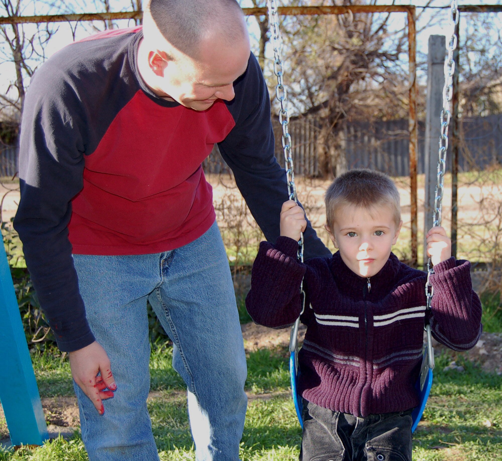Capt. Chad Wright, 376th Air Expeditionary Wing sexual assualt response coordinator, assists a Kyrgyz kindergartener on the swing set. Volunteers from the 376 AEW and Expeditionary Operations Group renovated and painted the swing set at the Solnyshko Kindergarten School near the village of Vinogradnoe, Kyrgyzstan. Capt. Wright is deployed from the 341st Space Wing at Malmstrom Air Force Base, Mont.
(U.S. Air Force Photo/Capt. Christy Stravolo)