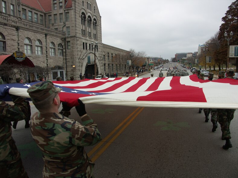 Veterans were honored by members of the 932nd Airlift Wing, Air Force Reserve Command, located at Scott Air Force Base, Ill.  They marched their huge American flag past the Hyatt Regency Hotel on the streets of Saint Louis.  It was a cold, blustery, November day but their hearts were warm as the people along the route clapped and cheered.  Photo/Capt. Stan Paregien
