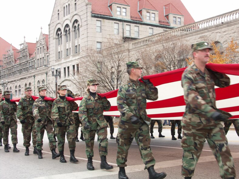 Airmen hold the line...Veterans were honored by members of the 932nd Airlift Wing, Air Force Reserve Command, located at Scott Air Force Base, Ill.  They marched their huge American flag through the streets of Saint Louis on a cold, blustery, November day.  Photo/Capt. Stan Paregien
