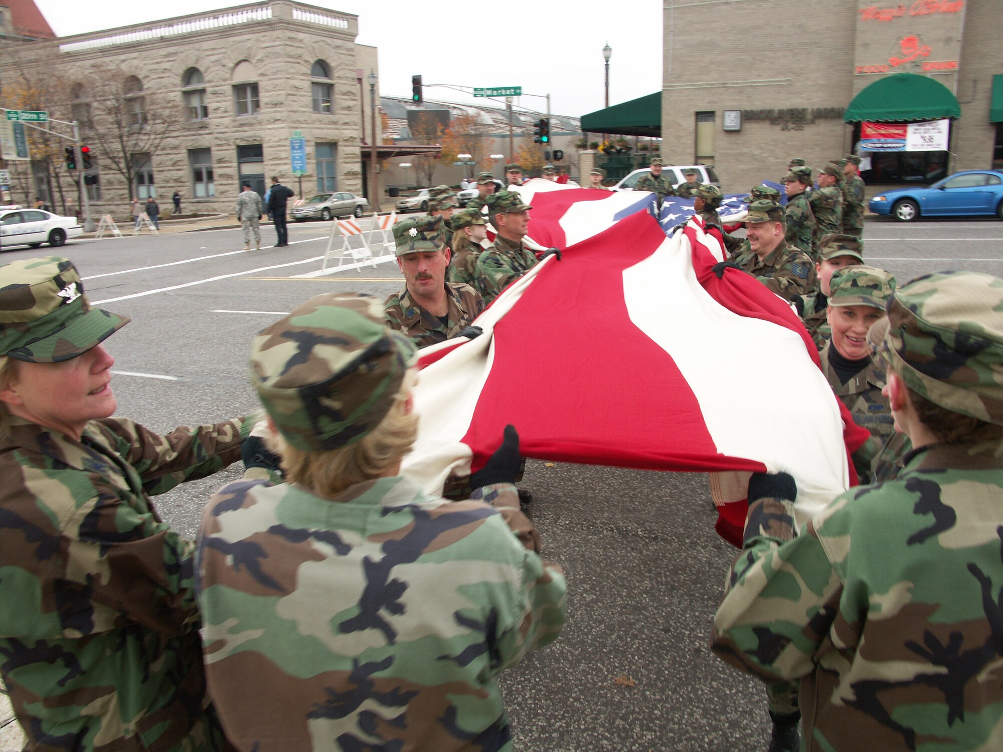 Col. Maryanne Miller, commander of the 932nd Airlift Wing, helps her Airmen fold the American flag at the end of the Saint Louis Veteran's Day event.  She and the Reservists are members of the Air Force Reserve Command.  Photo/Capt. Stan Paregien