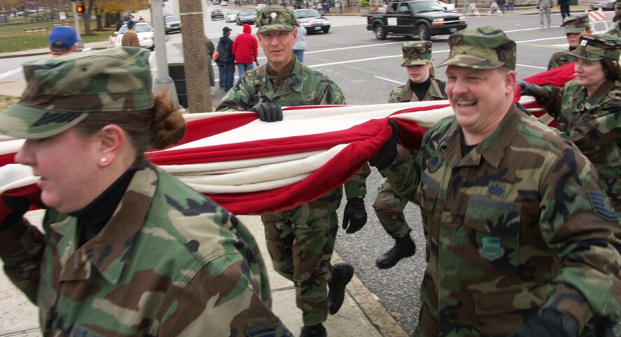 SMILE a while...Veterans were honored by members of the 932nd Airlift Wing, Air Force Reserve Command, located at Scott Air Force Base, Ill.  They marched their huge American flag through the streets of Saint Louis on a cold, blustery, November day.  Photo/Capt. Stan Paregien

