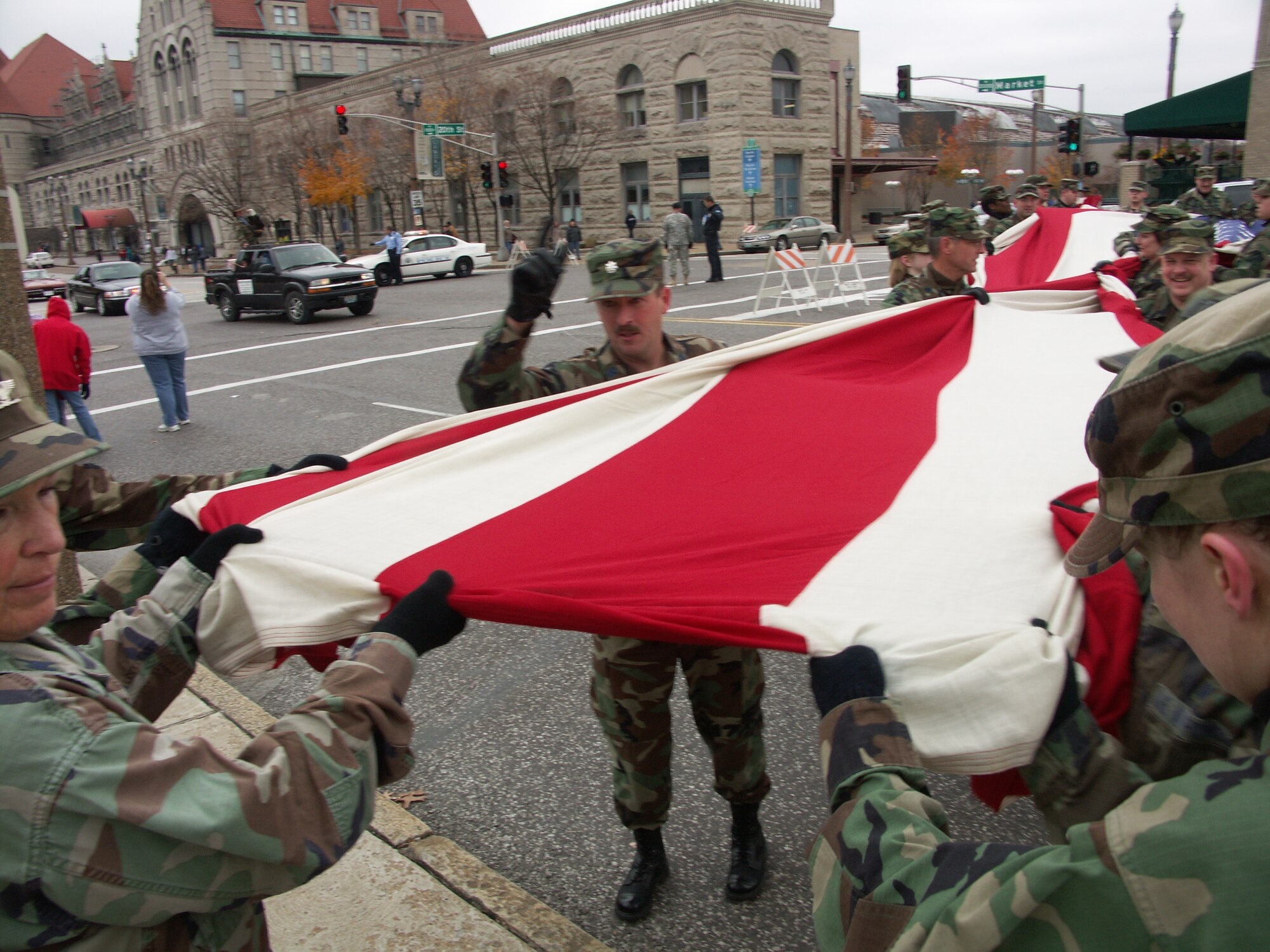 "March it that way ladies and gentlemen"...Patriotism is important to this Airman as he secures the American Flag.  Veterans were honored by members of the 932nd Airlift Wing, Air Force Reserve Command, located at Scott Air Force Base, Ill.  They marched their huge American flag through the streets of Saint Louis on a cold, blustery, November day.  Photo/Capt. Stan Paregien
