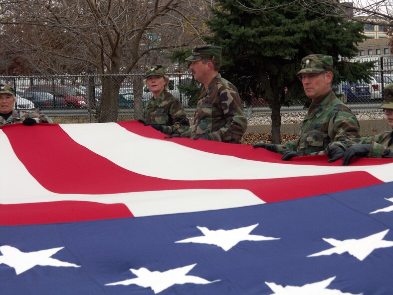Col. Maryanne Miller looks over the final folding of the 30 foot by 60 foot American flag.  Veterans were honored by members of the 932nd Airlift Wing, Air Force Reserve Command, located at Scott Air Force Base, Ill.  They marched their huge American flag through the streets of Saint Louis on a cold, blustery, November day.  Photo/Capt. Stan Paregien
