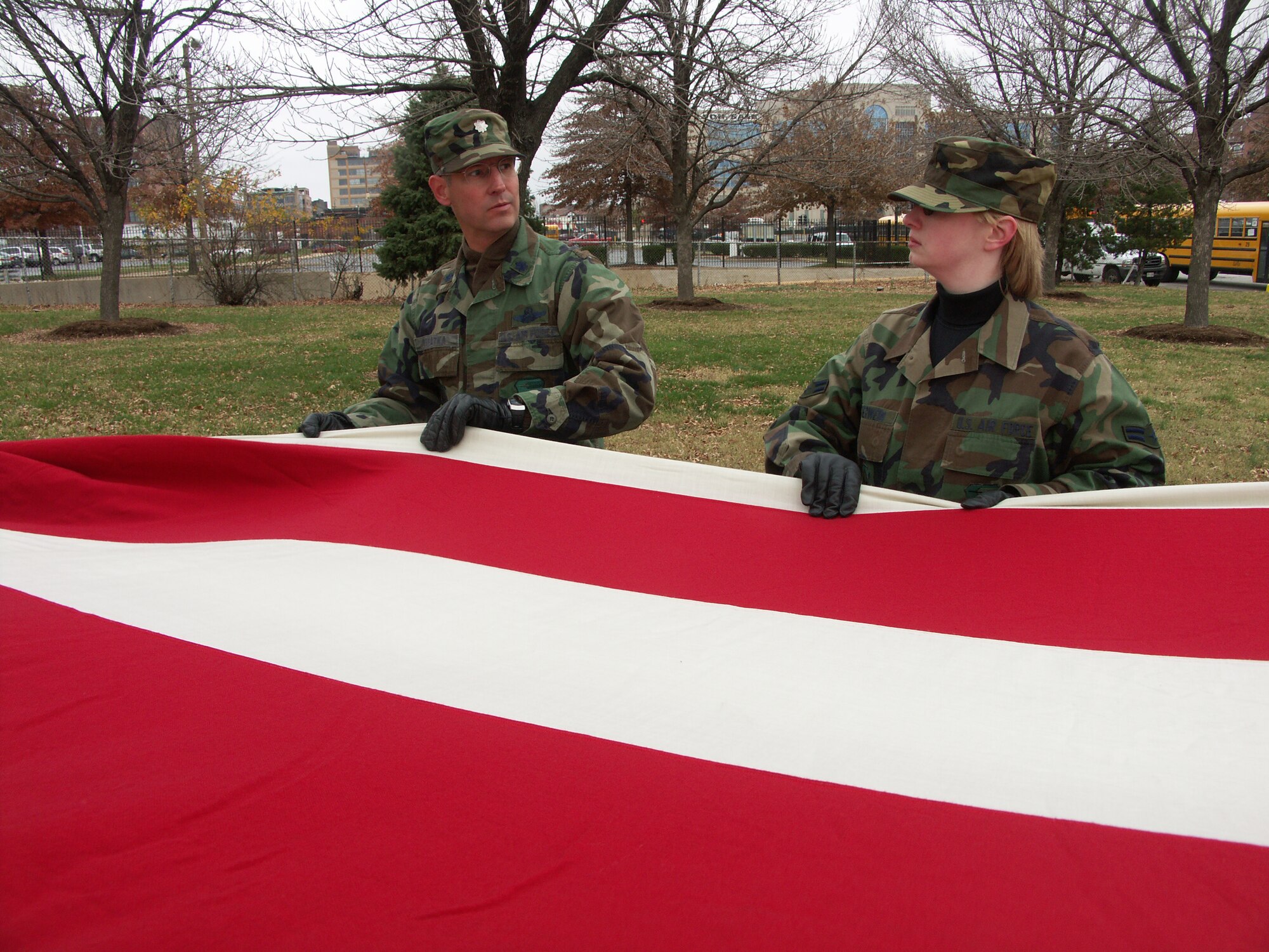 Airmen worked together to carry the heavy flag.  Veterans were honored by members of the 932nd Airlift Wing, Air Force Reserve Command, located at Scott Air Force Base, Ill.  They marched their huge American flag through the streets of Saint Louis on a cold, blustery, November day.  Photo/Capt. Stan Paregien
