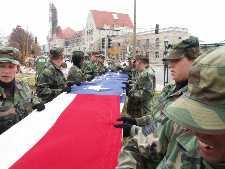 Love of country...Veterans were honored by members of the 932nd Airlift Wing, Air Force Reserve Command, located at Scott Air Force Base, Ill.  They marched their huge American flag through the streets of Saint Louis on a cold, blustery, November day.  Photo/Capt. Stan Paregien
