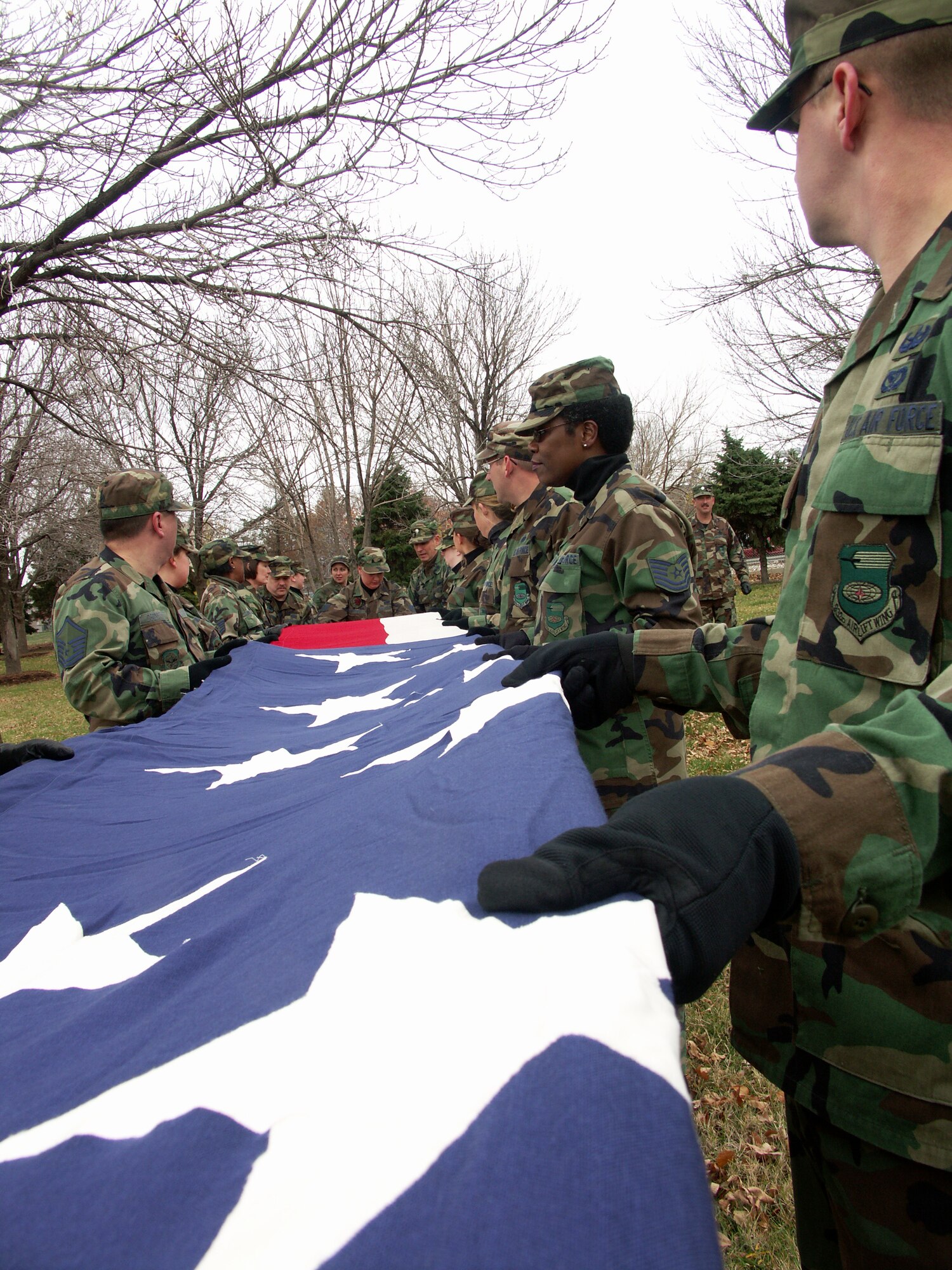 FINAL fold...Veterans were honored by members of the 932nd Airlift Wing, Air Force Reserve Command, located at Scott Air Force Base, Ill.  They marched their huge American flag through the streets of Saint Louis on a cold, blustery, November day.  Photo/Capt. Stan Paregien
