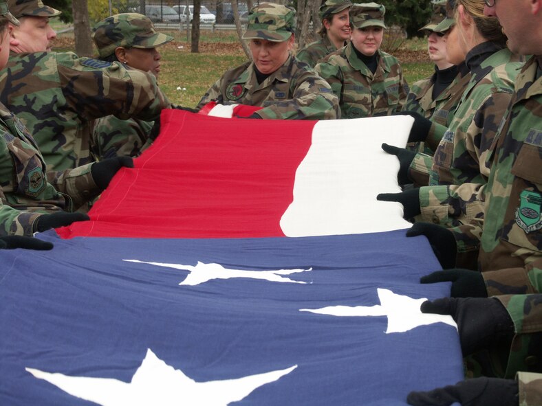 American Airmen...Veterans were honored by members of the 932nd Airlift Wing, Air Force Reserve Command, located at Scott Air Force Base, Ill.  They marched their huge American flag through the streets of Saint Louis on a cold, blustery, November day.  Photo/Capt. Stan Paregien
