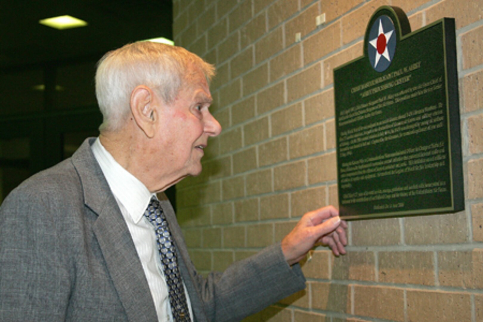 First Chief Master Sergeant of the Air Force, Paul W. Airey, reads a plaque historically naming the 319th Training Squadron to the Airey Processing Center at Lackland Air Force Base, Texas on Wednesday, June 14, 2006.  In all, nine Basic Training facilities were named for Enlisted heroes.                                 