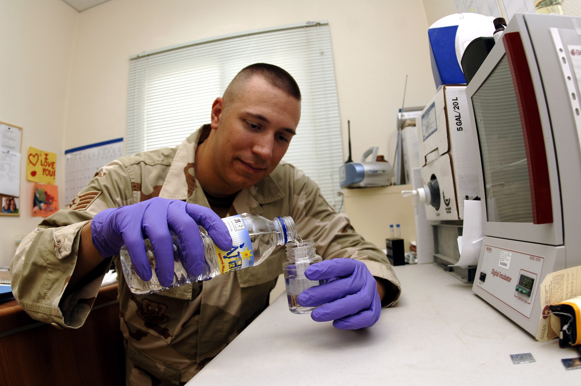Staff Sgt. Thomas Hefty tests a bottle water sample for bacteria and other impurities in Southwest Asia. The bioenvironmental engineering office certifies 1.2 million bottles of water consumed each month. Sergeant Hefty is a bioenvironmental engineering technician with the 379 Expeditionary Medical Group. (U.S. Air Force photo/Senior Airman Ricky Best)  