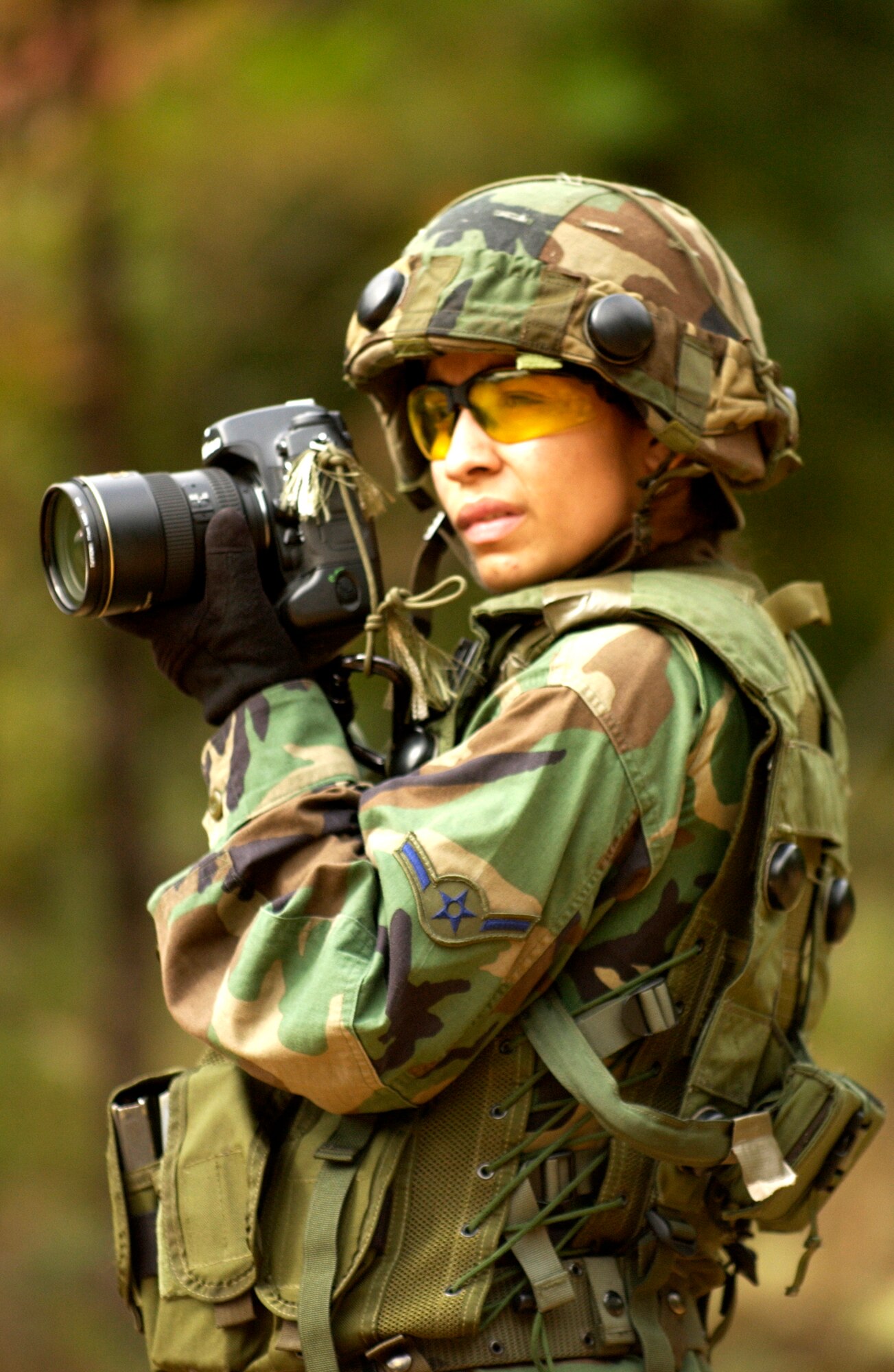 Airman Stephanie Longoria, 30th Space Communications Squadron, prepares to take a photograph during the "Ability To Survive and Operate" training at the North Auxillary Field, S.C.,  Oct. 18, 2006. The ATSO training was held by the 1st Combat Camera Squadronand is an annual exercise designed to train Airmen for real world contingencies and combat operations.  (U.S. Air Force photo by Airman 1st Class Christopher Hubenthal)
