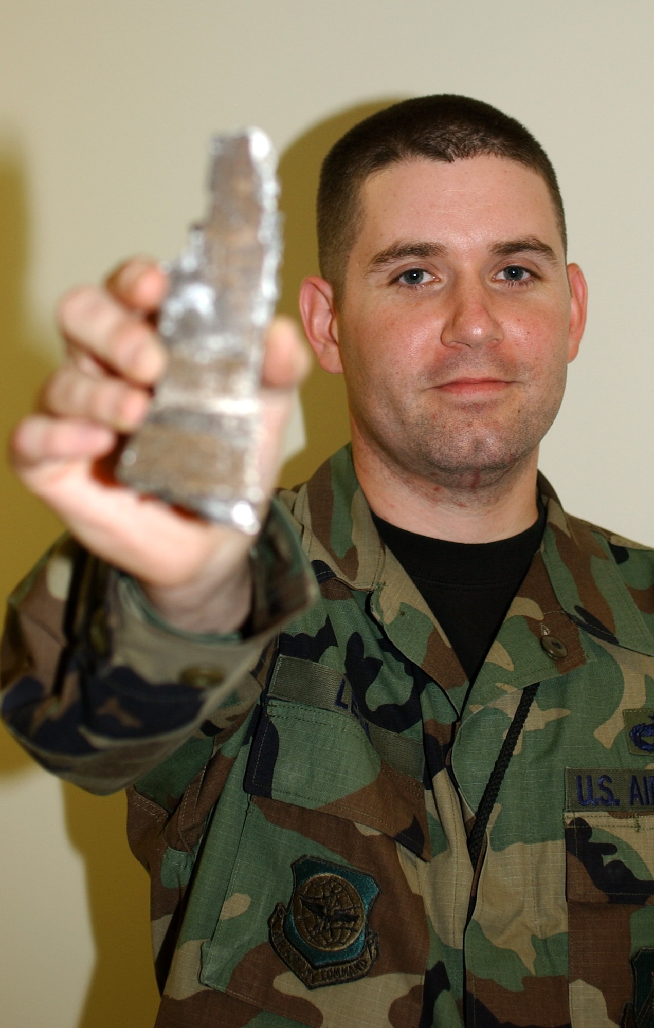 Staff Sgt. Chris Lelm holds up a piece of shrapnel found in his vehicle after a roadside bomb, made from a 155 mm artillery shell, exploded next to his truck in Iraq. Sergeant Lelm was one of many Airmen performing convoy duties in support of Operation Iraqi Freedom. Sergeant Lelm was presented the Purple Heart for his wounds. He is assigned to the 319th Logistics Readiness Squadron at Grand Forks Air Force Base, N.D. (U.S. Air Force photo/Airman 1st Class Ashley Coomes)