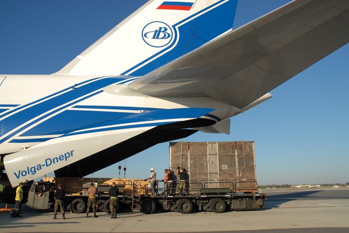 Airmen from the 437th Aerial Port Squadron, with help from Russian crew members, load cargo onto an Antonov AN-124 Ruslan, the largest mass-produced aircraft in the world. The AN-124 and its crew were contracted by the Tanker Airlift Control Center to airlift oversized cargo for the Space and Naval Warfare Systems Command to Iraq. (U.S. Photo by Airman 1st Class Sam Hymas) (RELEASED)