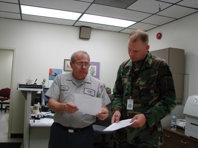 (Photo by Staff Sgt. Amanda Savannah) Stan Nowak, Computer Sciences Corporation lead quality monitor, and Tech. Sgt. Keith Jackson, Air Education and Training Command Maintenance Standard-ization and Evaluation Team member, review a list of defer items for parts Tuesday. The AETC MSET evaluated maintenance on Vance Monday through today.