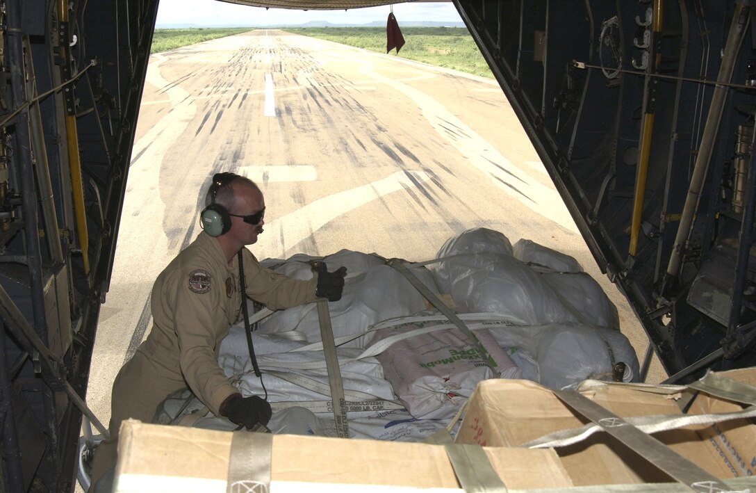 Tech. Sgt. James Cope prepares to release pallets containing food relief supplies for people affected by the flood in Gode, Ethiopia. Sergeant Cope is a loadmaster with the 746th Expeditionary Airlift Squadron in Southwest Asia. (U.S. Navy photo/Chief Petty Officer Phil Fortnam) 