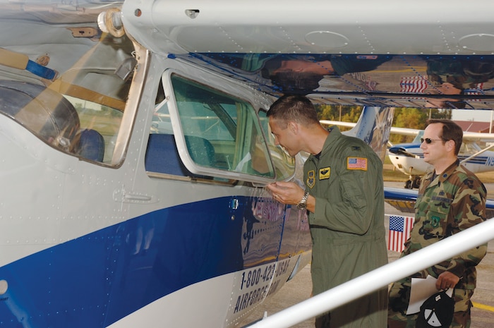 Col. Steven Harrison, 437th Airlift Wing vice commander, and Lt. Col. Todd Hackett, 437th Mission Support Group deputy commander, check out the newly painted plane at the Aero Club Tuesday. The Charleston Aero Club is one of the first in Air Mobility Command to have one of their planes painted. The Aero Club partnered with the Air Force Recruiting Service to paint the aircraft. The club received $55,000 from the recruiting service to paint five aircraft. The second Charleston Aero Club aircraft is presently undergoing repainting. To schedule a flight in the newly repainted plane contact the Aero Club at 963-5152. (U.S. Photo by Staff Sgt. Marie Cassetty) (RELEASED)