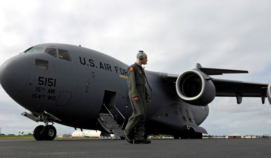 Senior Airman Nick Kaslin conducts a preflight on his C-17 Globemaster III prior to taking off on a local training mission Nov. 15 from Hickam Air Force Base, Hawaii. Airman Kaslin is a loadmaster with the 535th Airlift Squadron. (U.S. Air Force photo/Tech. Sgt. Shane A. Cuomo)