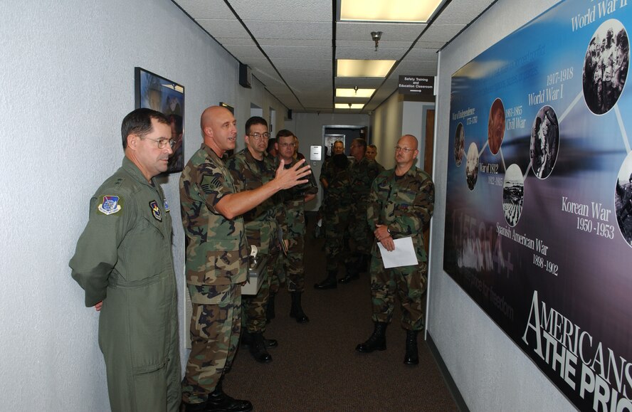 (Photo by Terry Wasson) Master Sgt. Lee Phillips, career assistance adviser, explains a mural in the first term Airmen’s center to Maj. Gen. Marc Rogers (left), 19th Air Force commander, during his visit to Vance Air Force Base Aug. 9 to 11. This was General Rogers’ first visit to Vance as the 19th AF commander. 
