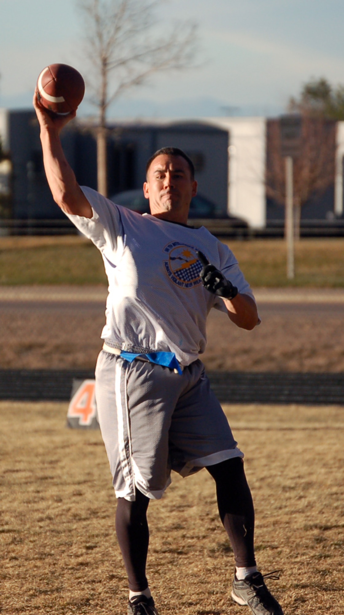 566th Information Operations Squadron quarterback Christian Moore throws a completed pass during the intramural championship football game against the 460th Operations Support Squadron/2nd Space Warning System team Nov. 16. The 566th IOS beat the 460th OSS/2nd SWS 13-0.