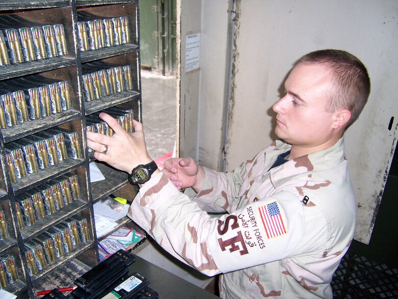 Senior Airman Creg Kinkead pulls out 210 rounds of 5.56 NATO ammunition, the amount used in a combat load for M4s. There are 24 ball round and six tracer rounds in each magazine. The tracers, which look like shooting stars when fired, are used to see where security forces are aiming at night. Airman Kinkead is a 379th Expeditionary Security Forces Squadron armory room attendant. (U.S. Air Force photo/Tech. Sgt Steve Staedler)