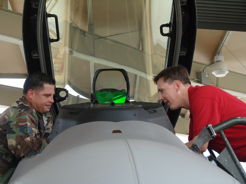 (Photo by Capt. Tony Wickman) Staff Sgt. Carlos Colon Otero, 43rd Aircraft Maintenance Unit, gives an overview of the F-22A Raptor cockpit to Jerald Gilbert, chief financial officer for the city of Enid. Twenty-six civilian business professionals, educators and politicians took the two-day trip to get a bigger view of the AETC and Air Force missions.