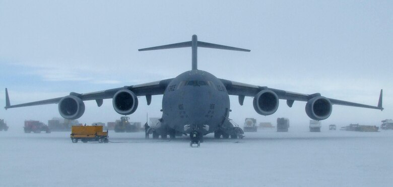 Vehicles transport equipment and supplies off a C-17 Globemaster III from McChord Air Force Base, Wash., Nov. 16, which landed on the sea ice runway near McMurdo Station, Antarctica. (U.S. Air Force photo/1st Lt. Erika Yepsen)