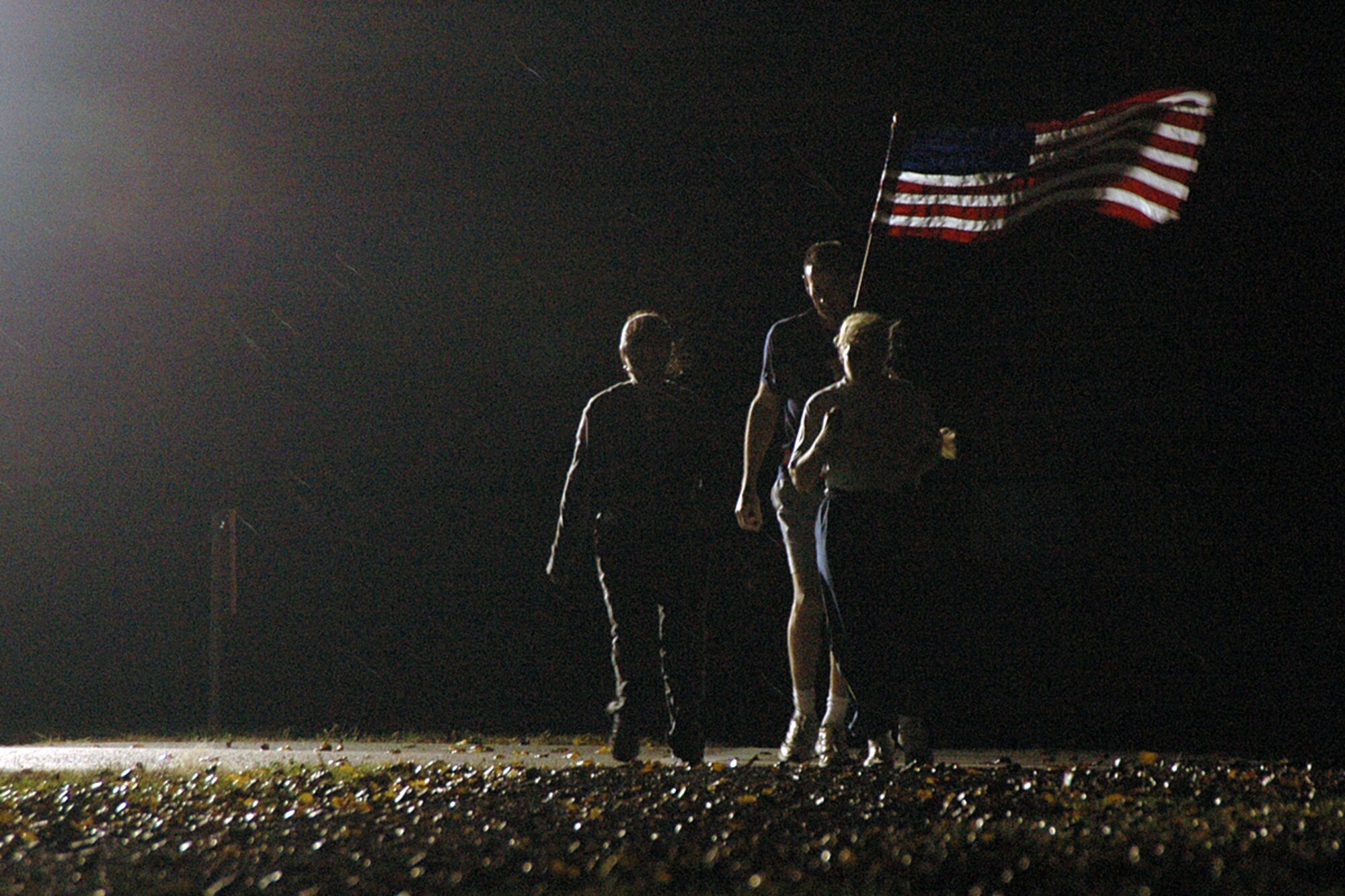 Team Scott members run the American flag during a 24-hour vigil in honor of veterans. Participants each completed a one-mile course, passing the flag from one to another. 