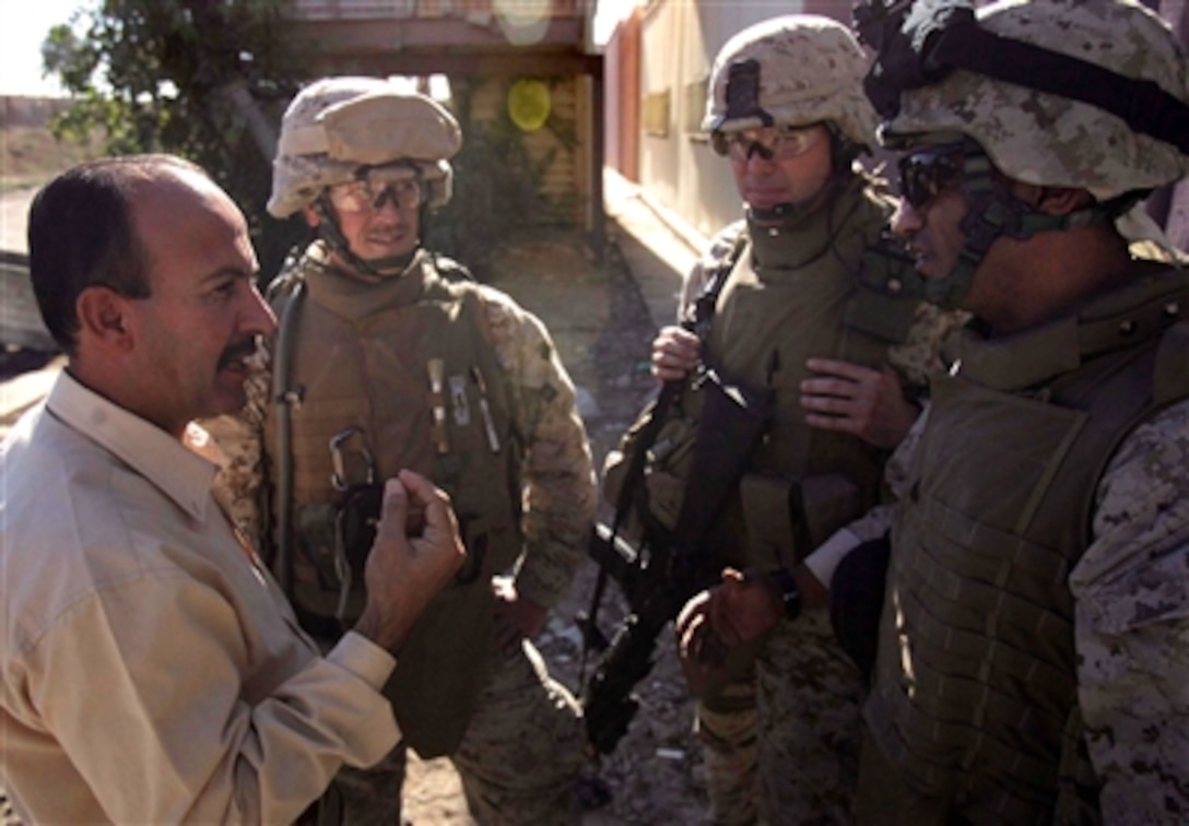 Members of the 4th Civil Affairs Group, attached to 1st Battalion, 6th Marine Regiment, speak with the director assistant of the Women’s and Children’s Hospital in Ar Ramadi, Iraq, Nov. 16, 2006.