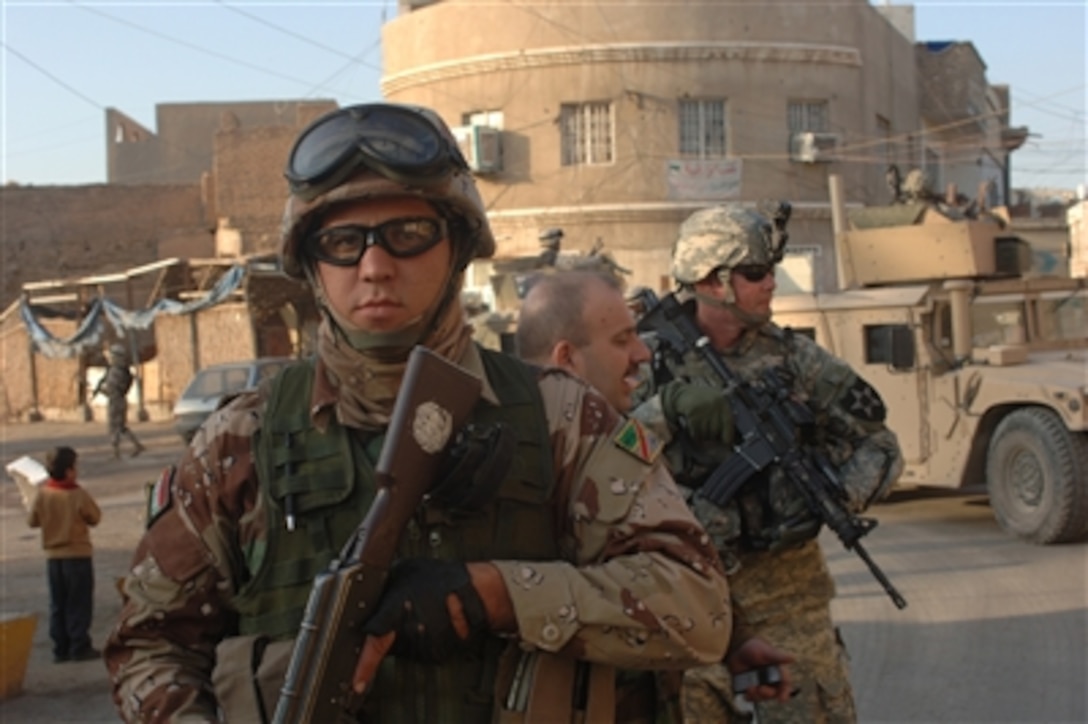 Iraqi army soldiers with 1st Battalion, 2nd Brigade, 6th Iraqi Army Division conduct a combined patrol with U.S. Army soldiers from the Military Transition Team of 2nd Battalion, 17th Field Artillery Regiment, 2nd Brigade Combat Team, 2nd Infantry Division in the Adhamiyah neighborhood of Baghdad, Iraq, on Nov. 13, 2006.  