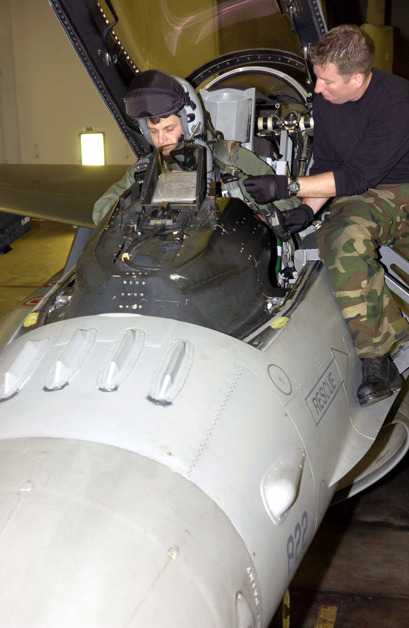 Lt. Col. Andrew Dembosky climbs into his F-16 Fighting Falcon for a mission with the 14th Fighter Squadron at Misawa Air Base, Japan, as Staff Sgt. Robert Parsons helps with preflight preparations.  The 14th FS is preparing to deploy to Iraq.  Colonel Dembosky is the inspector general for Misawa's 35th Fighter Wing.  (U.S. Air Force photo/Senior Airman Robert Barnett)