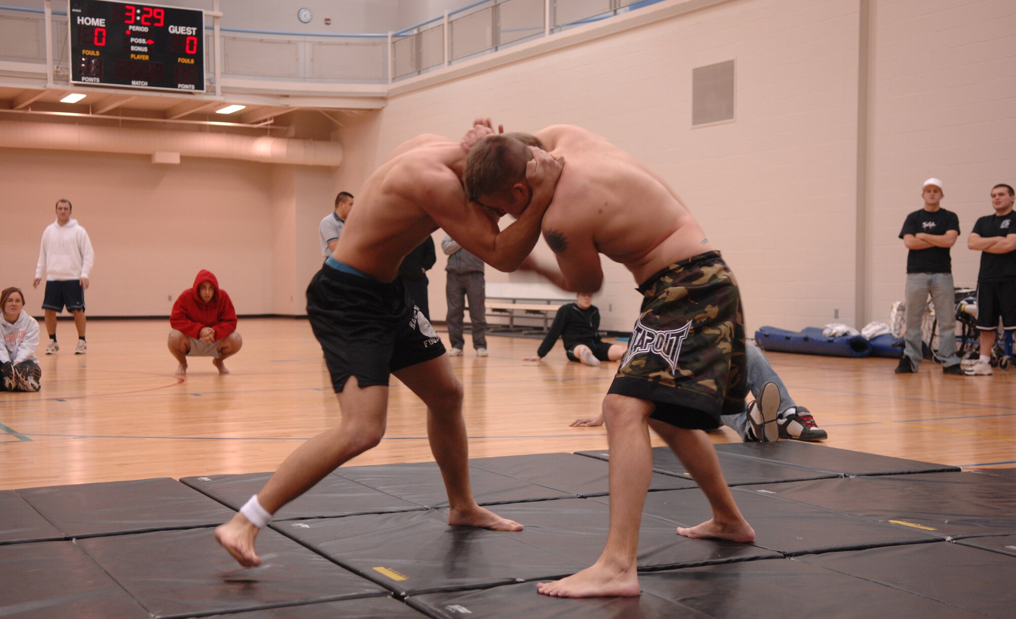 MINOT AIR FORCE BASE, N.D. -- From left: Senior Airman Christopher Schoenberg and Staff Sgt. Justin Welch, both from the 5th Logistics Readiness Squadron, battle for position during a grappling competition at the McAdoo Sports and Fitness Center Nov. 18. Sergeant Welch later won the match by a rear naked choke. (U.S. Air Force photo by Airman 1st Class Christopher Boitz)