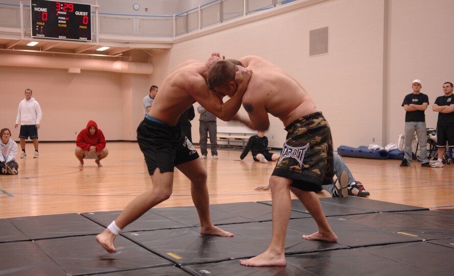 MINOT AIR FORCE BASE, N.D. -- From left: Senior Airman Christopher Schoenberg and Staff Sgt. Justin Welch, both from the 5th Logistics Readiness Squadron, battle for position during a grappling competition at the McAdoo Sports and Fitness Center Nov. 18. Sergeant Welch later won the match by a rear naked choke. (U.S. Air Force photo by Airman 1st Class Christopher Boitz)