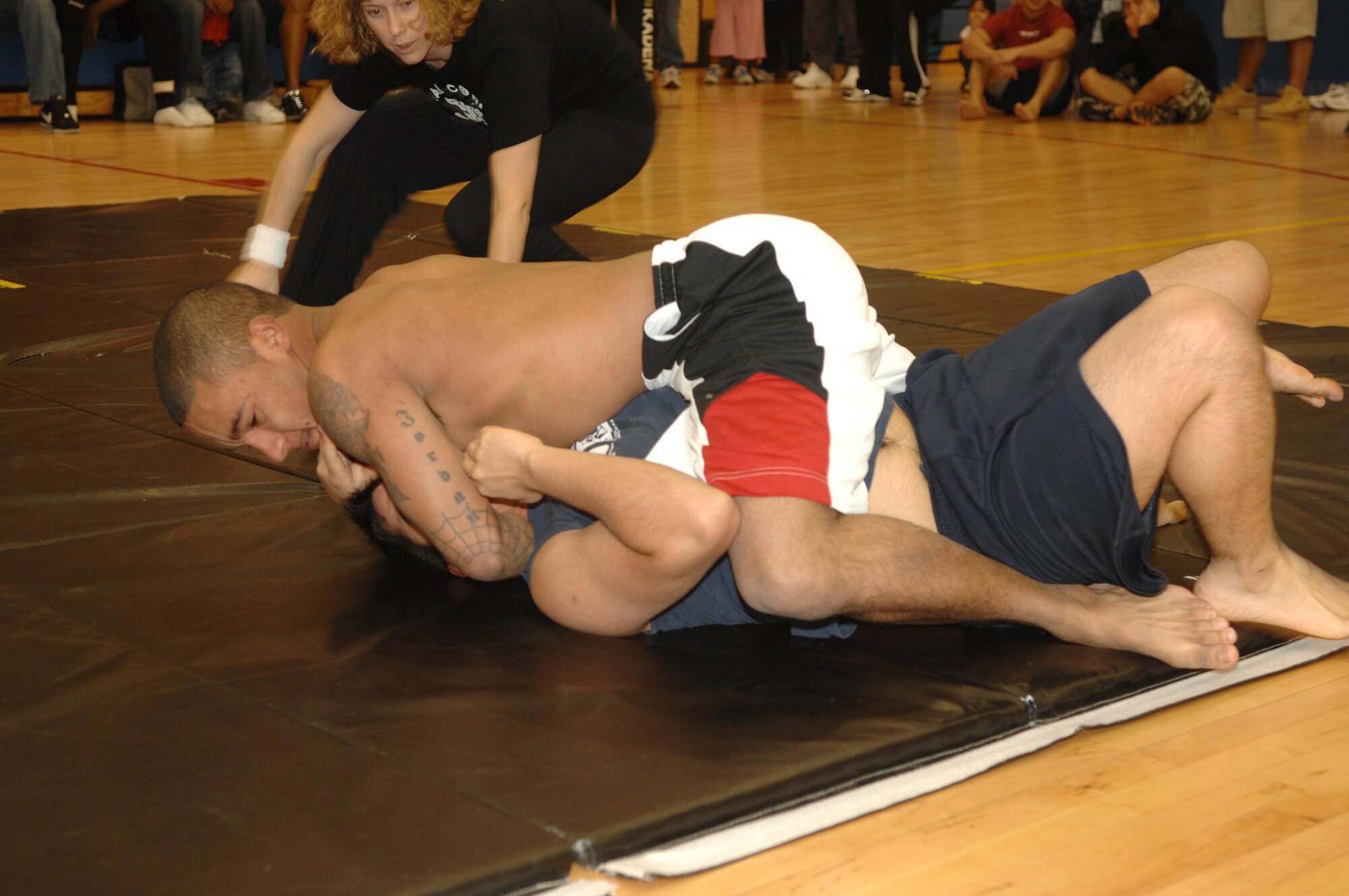 MINOT AIR FORCE BASE, N.D. -- Senior Airman Steven Jordan attempts to pin Airman Julian Pina, both from the 5th LRS, during a grappling competition at the McAdoo Sports and Fitness Center Nov. 18. Airman Jordan won the match by submission. (U.S. Air Force photo by Airman 1st Class Christopher Boitz)