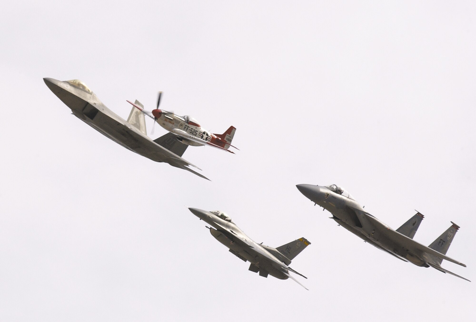 The Air Combat Command heritage flight was one of many demonstrations during the Nellis air show. The flight consists of (from top) an F-22 Raptor, P-51 Mustang, F-15 Eagle and F-16 Fighting Falcon. (U.S. Air Force photo/ Master Sgt. Kevin Gruenwald)