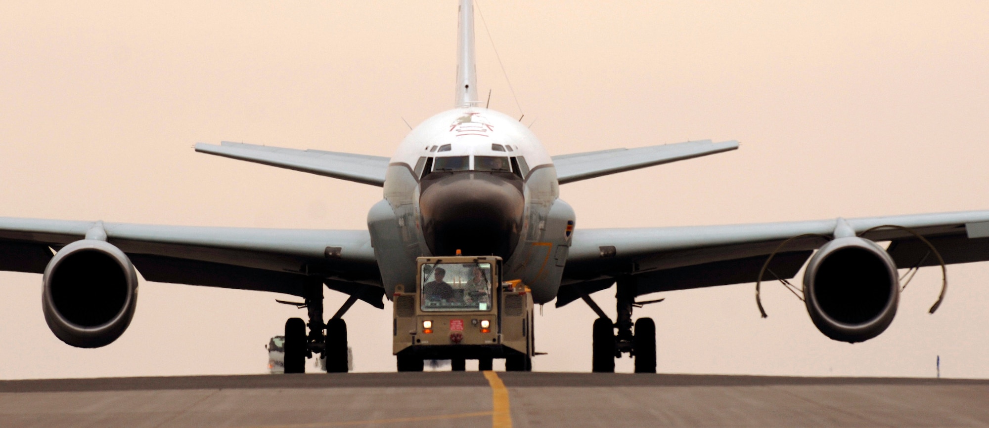 An RC-135 Rivet Joint reconnaissance aircraft is towed by Staff Sgt. John Terlaje and Airman 1st Class Ross Vandenbosch in Southwest Asia. The F108-model high bypass turbofan engine, introduced to the 135-airframe in August of 1998, has proven to be a reliable workhorse in transporting the heavy 275,000-pound intelligence and reconnaissance platform. Both crew chiefs are deployed from the 55th Aircraft Maintenance Squadron from Offutt Air Force Base, Neb. (U.S. Air Force photo/Master Sgt. Scott Wagers)
