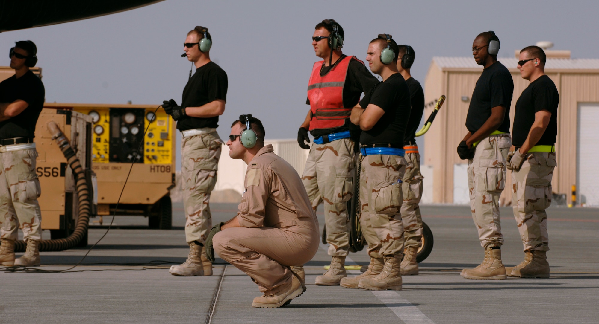 First Lt. Drew Townsend and a group of crew chiefs from the 55th Aircraft Maintenance Unit verify movement of the reconnaissance plane's wing flaps in preparation for a mission over Southwest Asia. RC-135 Lieutenant Townsend is an RC-135 co-pilot, and the 55th AMU Airmen are from Offutt Air Force Base, Neb. (U.S. Air Force photo/Master Sgt. Scott Wagers)