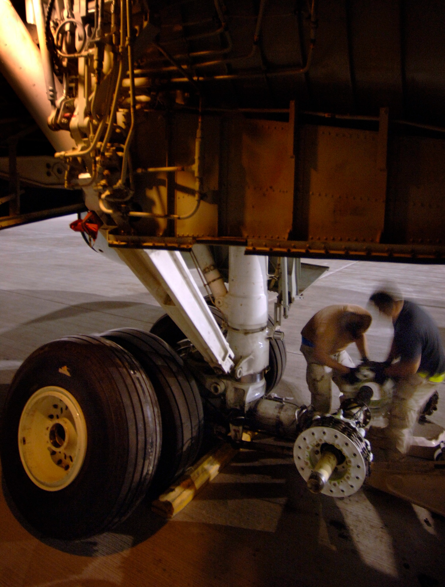 Staff Sergeants Steven Lantz and John Terlaje change out both tires and a 250-pound brake assembly on the main landing gear of a RC-135 Rivet Joint aircraft that is forward deployed in Southwest Asia. Both crew chiefs are deployed from the 55th Aircraft Maintenance Squadron at Offutt Air Force Base, Neb. (U.S. Air Force photo/Master Sgt. Scott Wagers)
