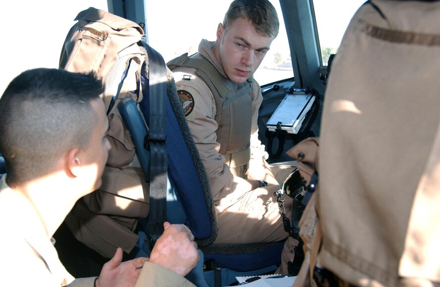 Senior Airman Rodney Simpson (left), 332nd Expeditionary Operations Support Squadron intelligence analyst currently at Balad Air Base, Iraq, debriefs an aircrew member Nov. 17, 2006, after a mission. Airman Simpson is deployed from Shaw Air Force Base, S.C. (U.S. Air Force photo/Senior Airman Josh Moshier)                             