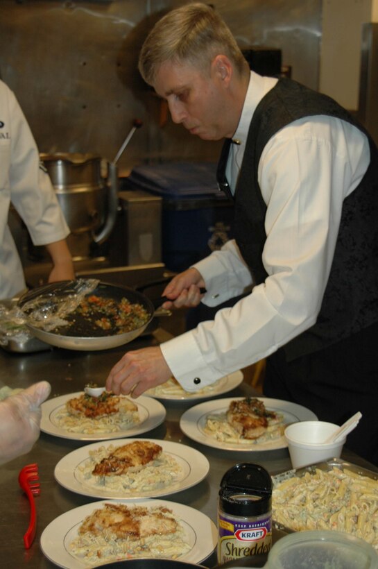 Tech. Sgt. Wesley Williams, 28th Services Squadron dining facility manager, garnishes a dish at Ellsworth’s Bandit Inn for a farewell luncheon for Airmen in his unit. Sergeant Williams has served Air Force leadership and other distinguished guests at the Pentagon; now this chef is bringing his culinary skills to Ellsworth. (Photo by Airman Nathan Riley)