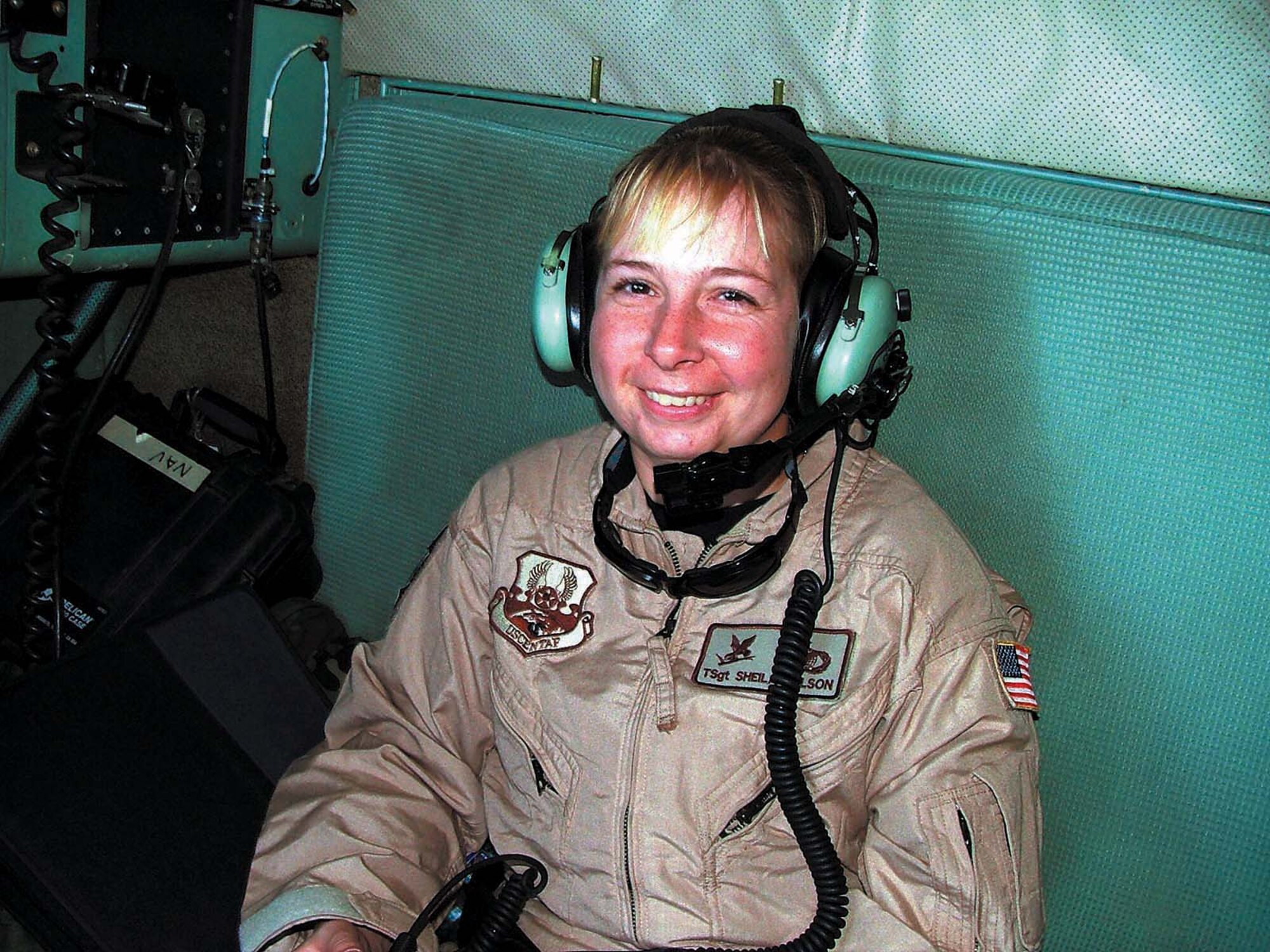 Tech. Sgt. Sheila Wilson rides on board a C-130 Hercules and listens in to aircrew communications during a Nov. 19 flight supporting Operation Enduring Freedom. Sergeant Wilson is one of nine security forces members from Ellsworth Air Force Base, S.D., who received fly away security team training prior to deploying. FAST missions are designed to provide the mandatory security level for Air Force aircraft even though the specific mission may require the airplane to land at remote and undisclosed locations. Sergeant Wilson is deployed from the 28th Security Forces Squadron at Ellsworth AFB. (U.S. Air Force photo)