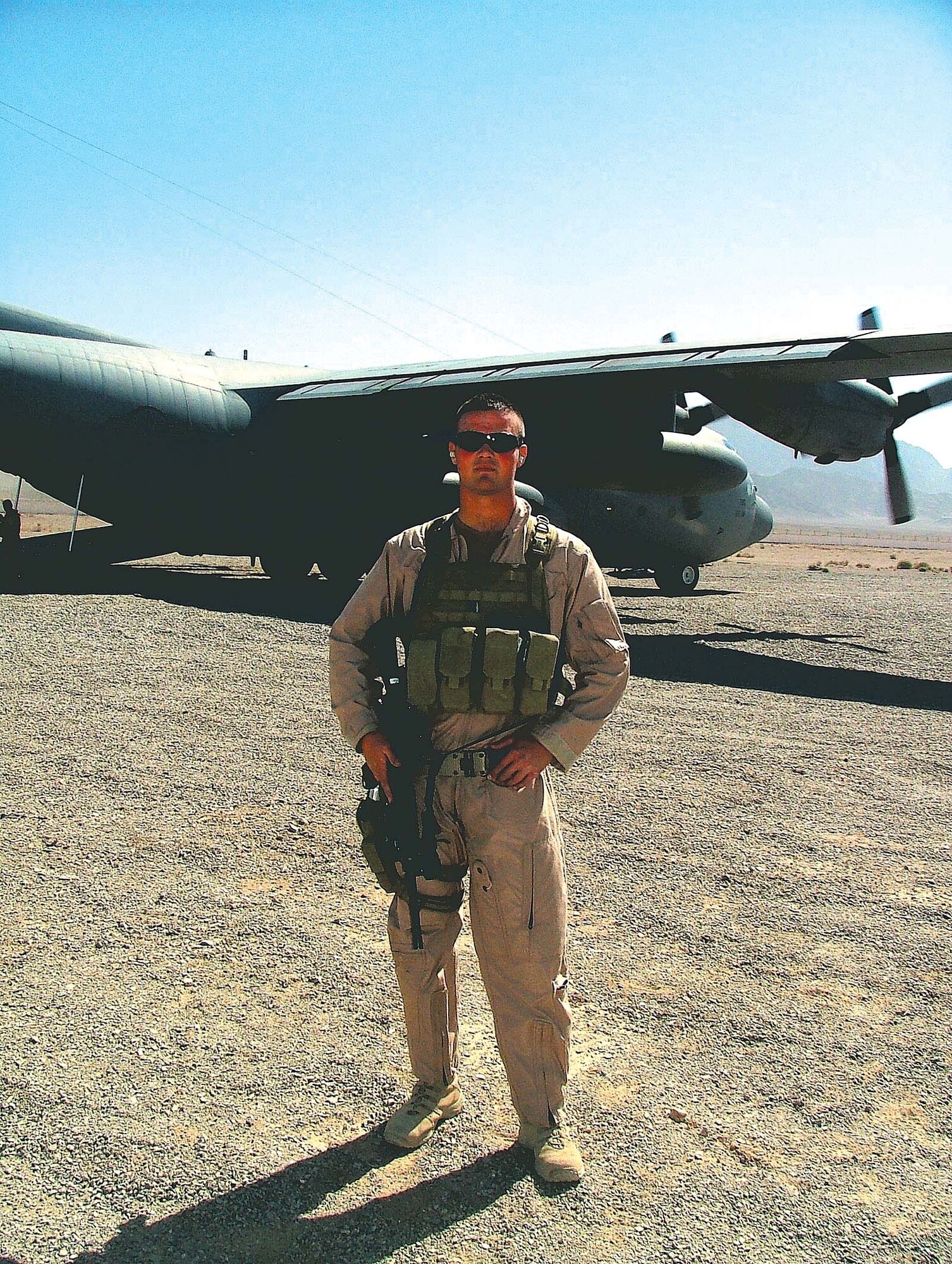 Senior Airman Kyle Battell secures an avenue of approach from potential adversaries for a C-130 Hercules Nov. 19 in Afghanistan. Airman Battell is one of nine security forces members from Ellsworth Air Force Base, S.D., who received fly away security team training prior to deploying. This aircraft is off loading cargo at an undisclosed location in Afghanistan. Airman Battell is deployed from the 28th Security Forces Squadron at Ellsworth AFB. (U.S. Air Force photo) 