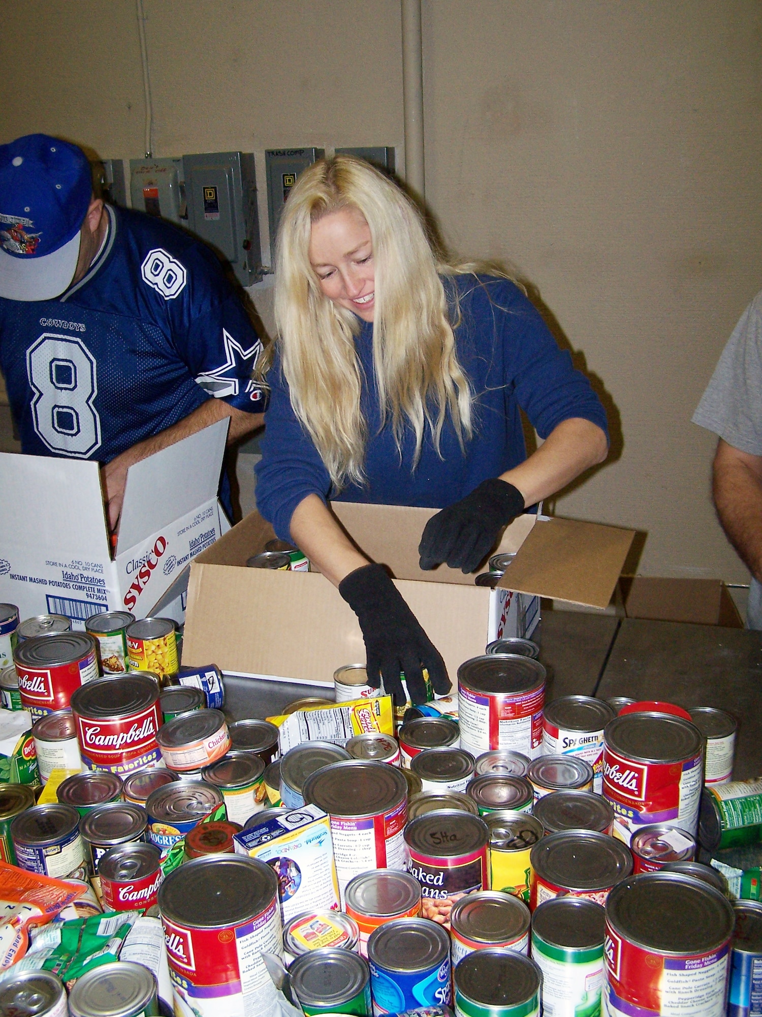 Staff Sgt. Lucinda Emerson, a pharmacy technician with the 21st Medical Group, sorts food Nov. 20 at the Care and Share food bank. Over the course of five days, volunteers from Peterson and surrounding military bases picked up, sorted and packaged about 100,000 pounds of food. The food will be distributed to food banks across Southern Colorado. (U.S. Air Force photo by Steve Brady)