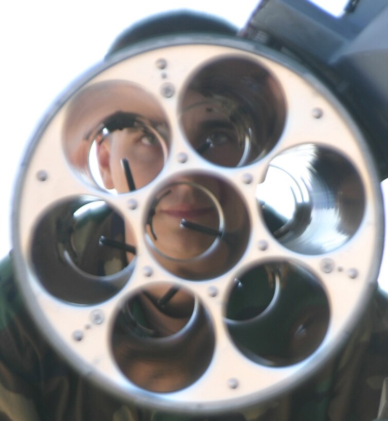 Student pilots and Airmen-in-Training, from the 80th Flying Training Wing and 82nd Training Wing respectively, took time to look at various aircraft Nov. 17 at the 80th FTW's annual Combat Air Force Day. Here, 360th Training Squadron Airman Joel Reed, a C-130 crew chief Airman-in-Training from Seattle, looks through the tubes of a rocket launch system on an F-16 Falcon. (U.S. Air Force photo/John Ingle)